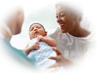 Doctor handing newborn baby to mom